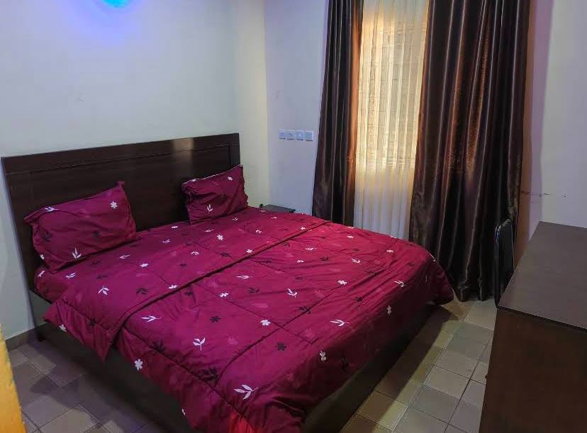 Guest room with burgundy bedding